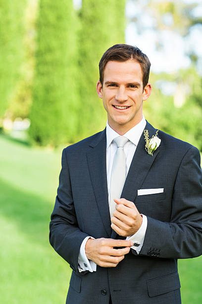 istock Happy Groom Adjusting Sleeve In Garden 516814761