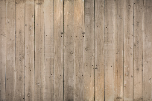 Reclaimed wood planks with water stains and nail holes.