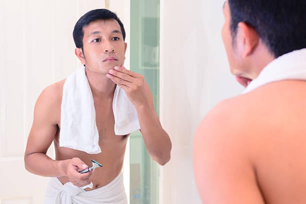 istock Young handsome man touching his smooth face after shaving. 516815510