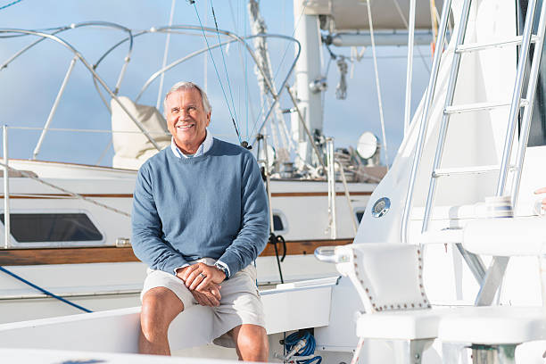 istock Senior man at boat dock sitting on yacht 516815664