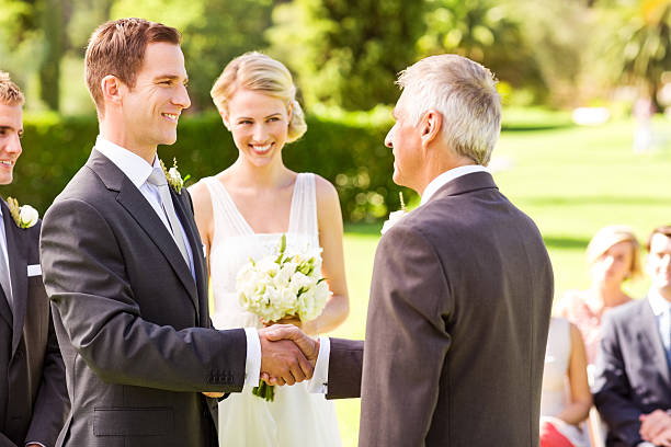 istock Groom Shaking Hands With Father In Garden 516815869