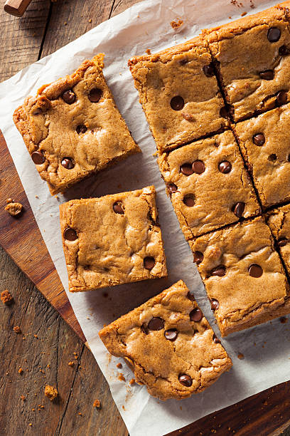 Homemade Chocolate Chip Blondies Homemade Chocolate Chip Blondies Cut Into Squares blondy stock pictures, royalty-free photos & images