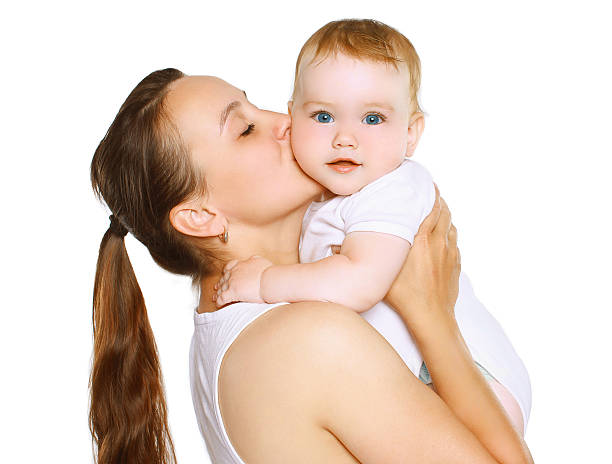 Mom kissing baby