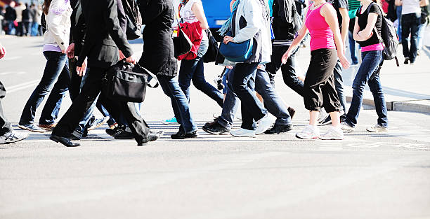 istock Pedestrian crowd crossing street, bus in background 516815983