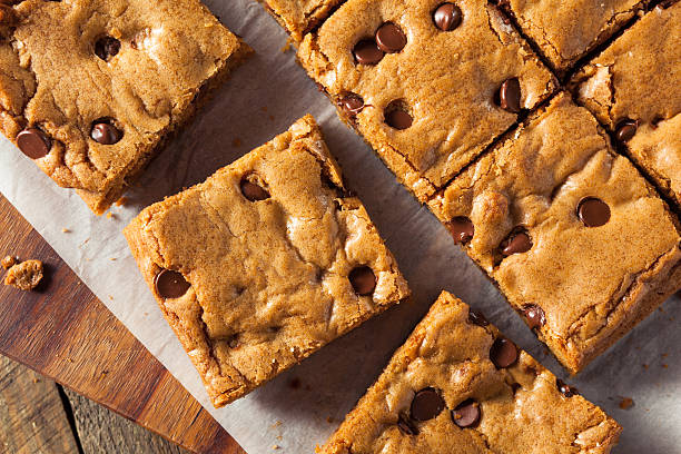 Homemade Chocolate Chip Blondies Homemade Chocolate Chip Blondies Cut Into Squares blondy stock pictures, royalty-free photos & images