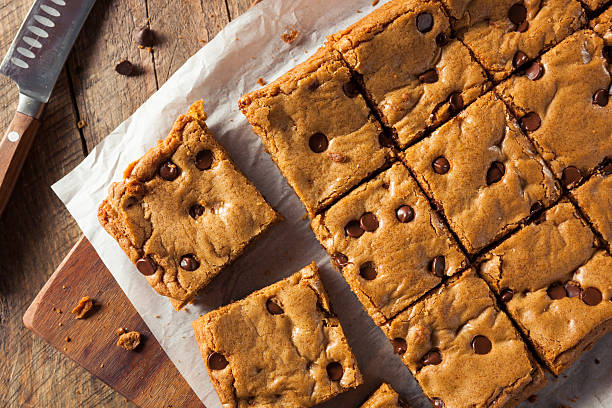 Homemade Chocolate Chip Blondies Homemade Chocolate Chip Blondies Cut Into Squares blondy stock pictures, royalty-free photos & images