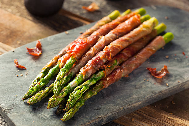 Homemade Prosciutto Wrapped Asparagus Homemade Prosciutto Wrapped Asparagus with Salt and Pepper asparagus stock pictures, royalty-free photos & images