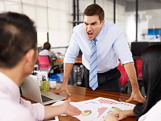 boss yelling at subordinates bad-tempered caucasian business executive yelling at two asian subordinates in office. subordination stock pictures, royalty-free photos & images