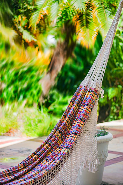 istock Empty colorful cloth and rope hammock hanging garden patio 516819428