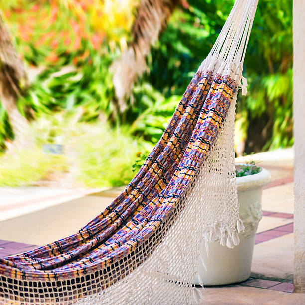 istock Empty colorful cloth rope hammock hanging garden patio square composition 516819640