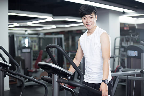 istock young handsome man works out in modern gym 516820710