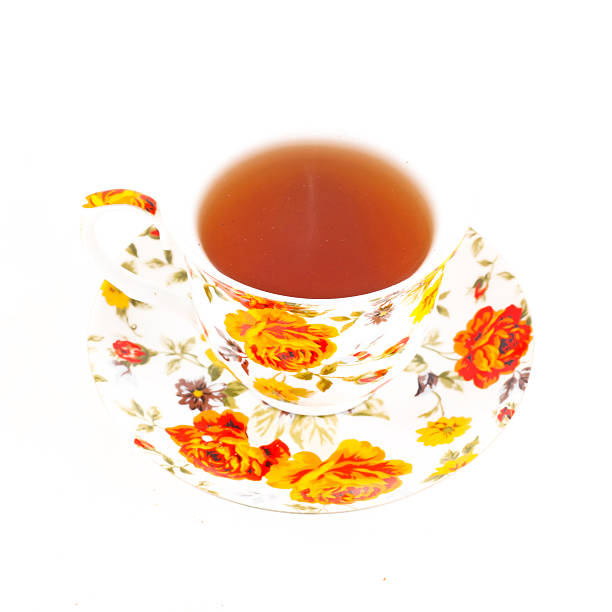 istock Classic tea cup with red and orange flowers 516820858