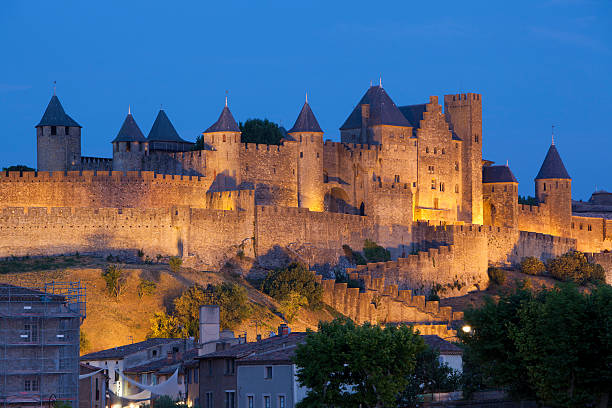 Carcassonne, France - July 20, 2013: Medieval citadel of Carcassonne at night. Carcassonne is in the Aude department and chief town of the Languedoc-Roussillon region in the south-west France. Its historic center consists of a walled medieval citadel protected by UNESCO since 1997.