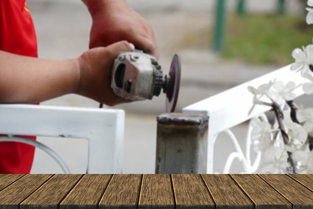 istock The worker use metal grinding wheel to grind iron pole 516825850