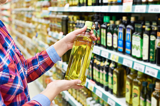 Buyer with the sunflower oil in a store