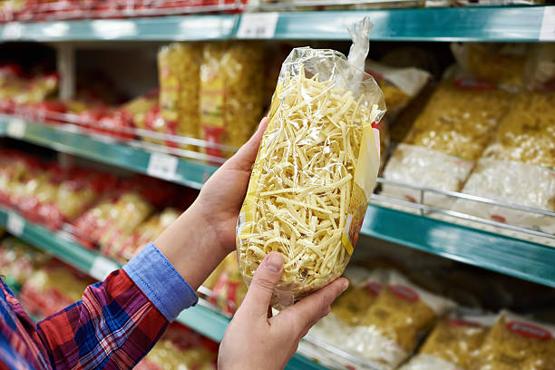istock Buyer with package pasta in shop 516826224