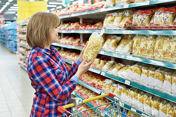 istock Woman with package pasta in shop 516826248