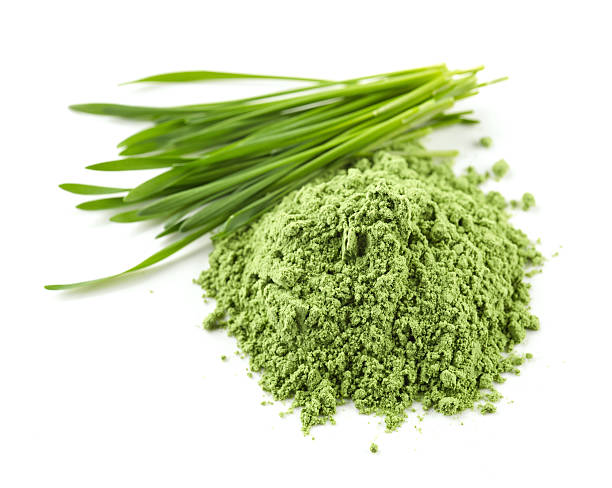 堆積緑色のパウダー - wheatgrass ストックフォトと画像