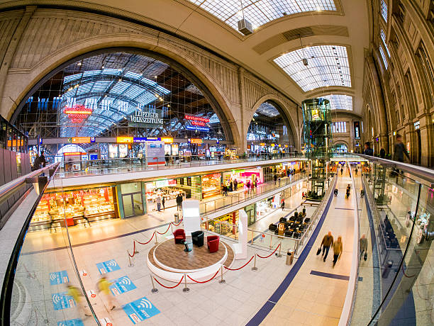 Leipzig, Germany - May 4, 2014: People scattered all over the Concourse in the Leipzig Hauptbahnhof in Germany. Various shops can be seen in the photo.