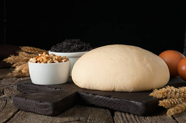 istock Fresh dough with ingredients to make cake or strudel 516844260