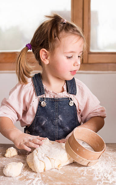 istock little girl baking 516844636