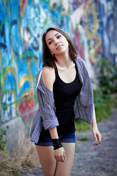 istock Young girl on graffiti background 516845254