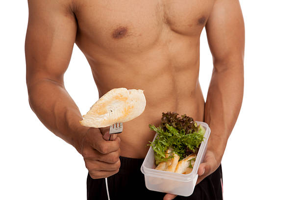 healthy meal with chicken and vegetables on a porcelain plate in a gymnasium - diet concept