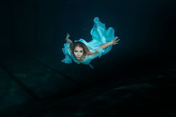 istock Woman mermaid under water. 516846898