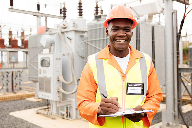 african american electricity company worker portrait of african american electricity company worker in substation electrician smiling stock pictures, royalty-free photos & images