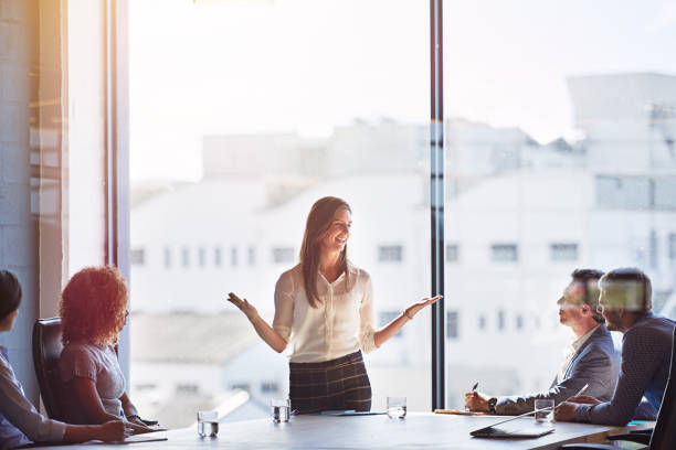 Explaing her ideas in detail Shot of businesspeople having a meeting in a boardroom skill stock pictures, royalty-free photos & images