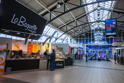 Oslo, Norway  - July 19, 2015: Man buying food in Cafe, Oslo Central train station