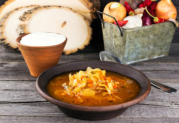 istock Russian cabbage soup in clay plate on a wooden background 516849186