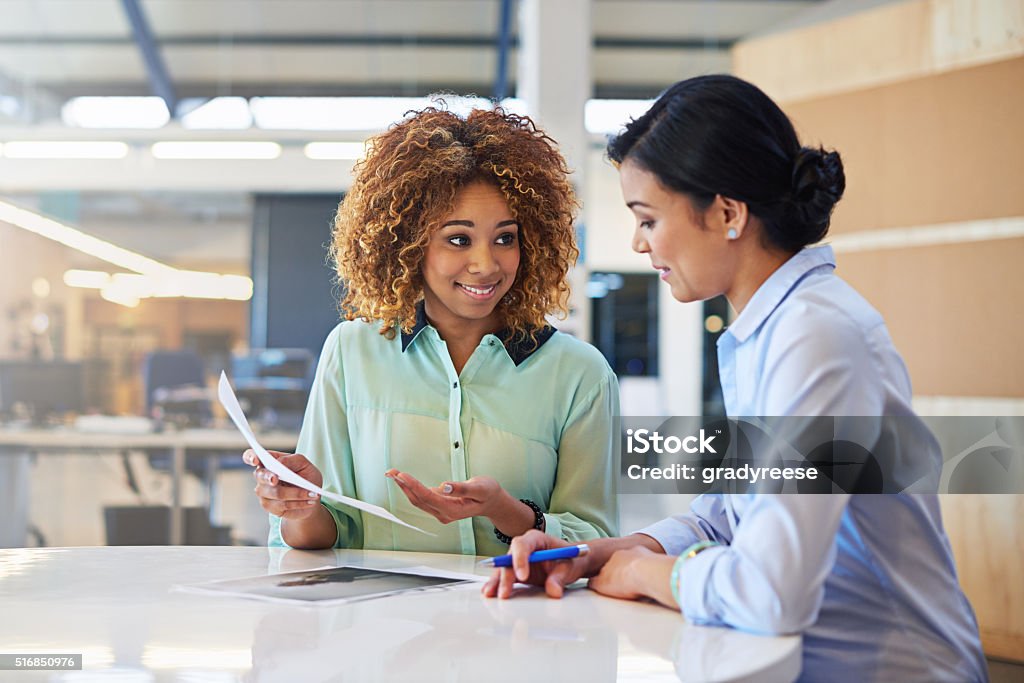 I think this is done! Shot of two businesswoman working together in an office Business Meeting Stock Photo