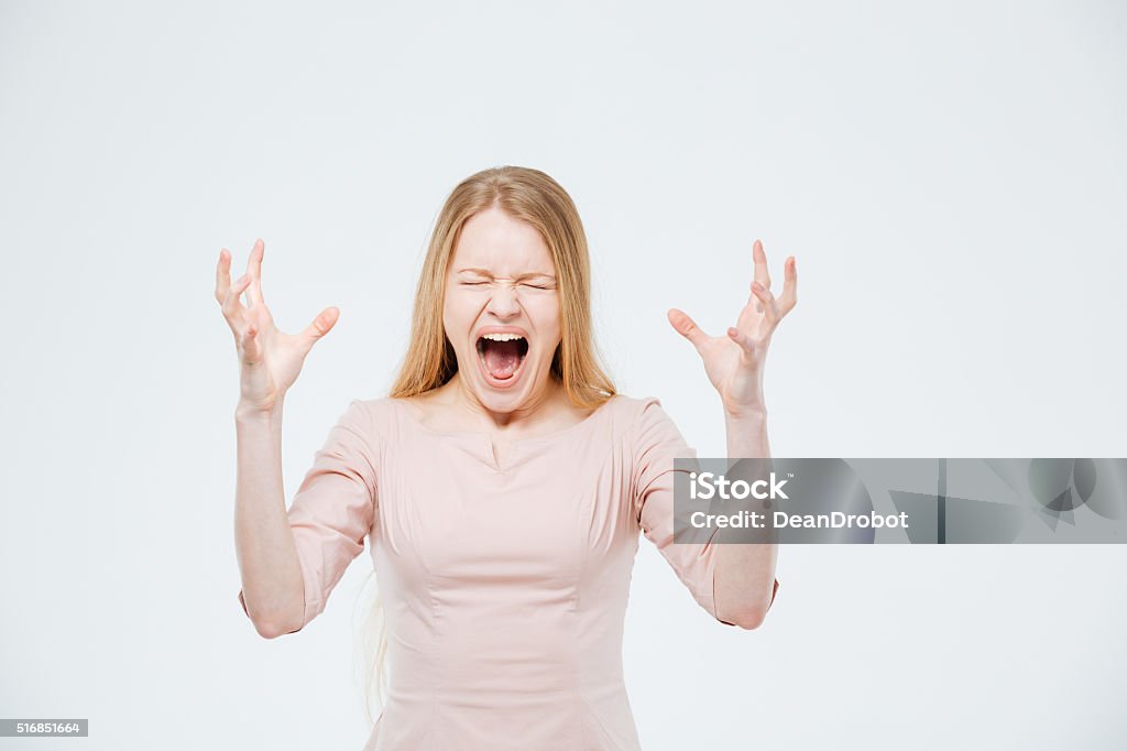 Angry woman screaming Angry woman screaming isolated on a white background Adult Stock Photo