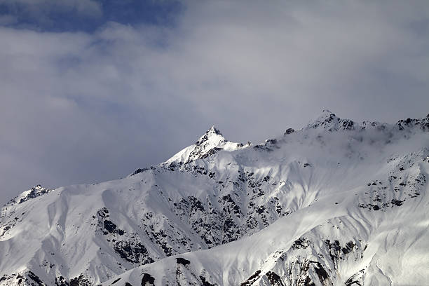 istock Sunlight mountain peak and cloudy sky in evening 516852832