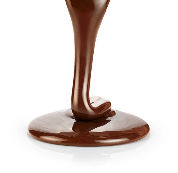 istock Pouring dark melted chocolate isolated on white background. 516853410
