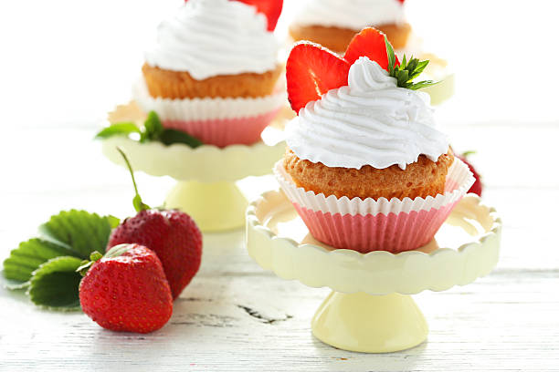 istock Tasty cupcake with strawberry on cake stand 516853636