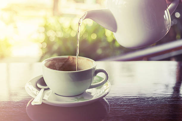 istock Cup of coffee with water splashing from hot pot 516853716