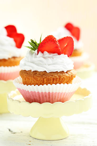 istock Tasty cupcake with strawberry on cake stand 516853772