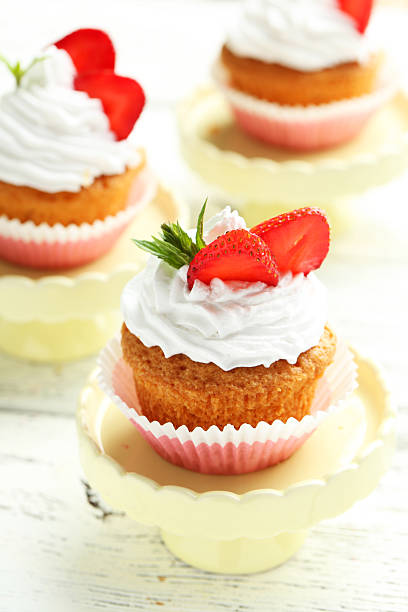 istock Tasty cupcake with strawberry on cake stand 516853824