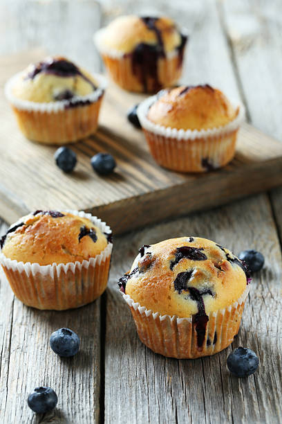 istock Tasty blueberry muffins on a grey wooden background 516854536