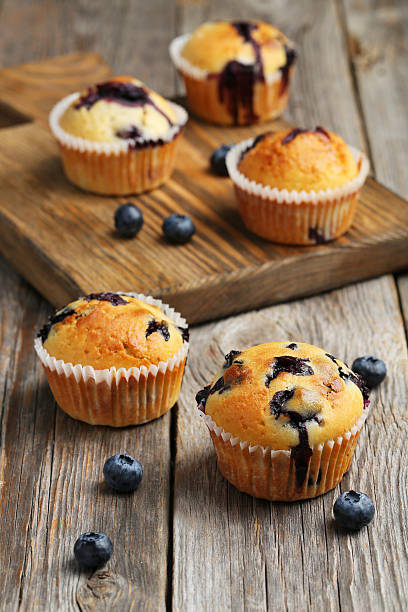istock Tasty blueberry muffins on a grey wooden background 516854572