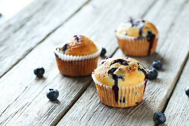 istock Tasty blueberry muffins on a grey wooden background 516854826