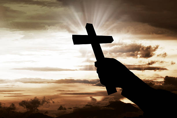 istock Human hand holding christian cross 516856142