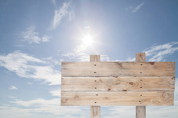istock wooden signboard on blue sky  for summer background 516856182