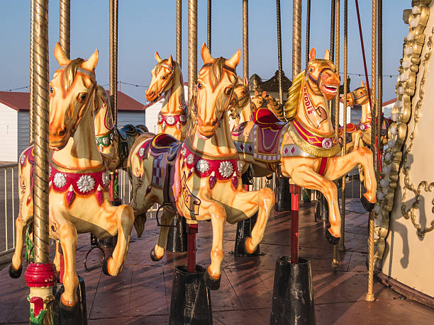 Traditional painted carousel horse with natural background motion blur at an English seaside resort