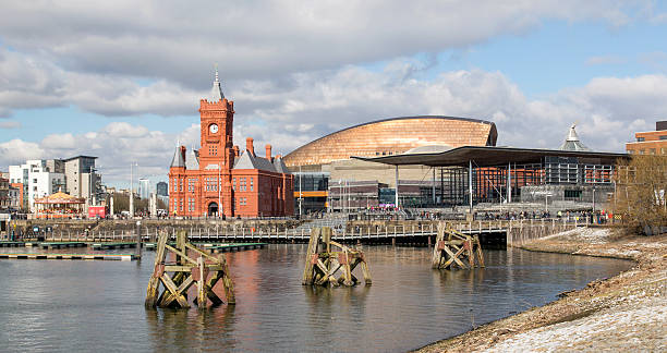 Cardiff Bay - National Assembly Cardiff, UK: March 10, 2016: Cardiff Bay is the area created by the Cardiff Barrage in South Cardiff, the capital of Wales. Tourists are enjoying the Millennium Centre, National Assembly and Pier Head Buildings.  national assembly for wales stock pictures, royalty-free photos & images