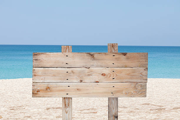 istock wooden signboard on blue sky and on tropical beach 516856676