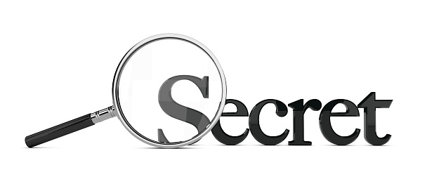 Magnifying glass enlarging the word secret