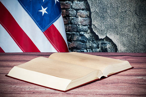 Opened book on a background of the USA flag stock photo